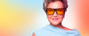 A close-up portrait of a woman with short gray hair wearing oversized black sunglasses.